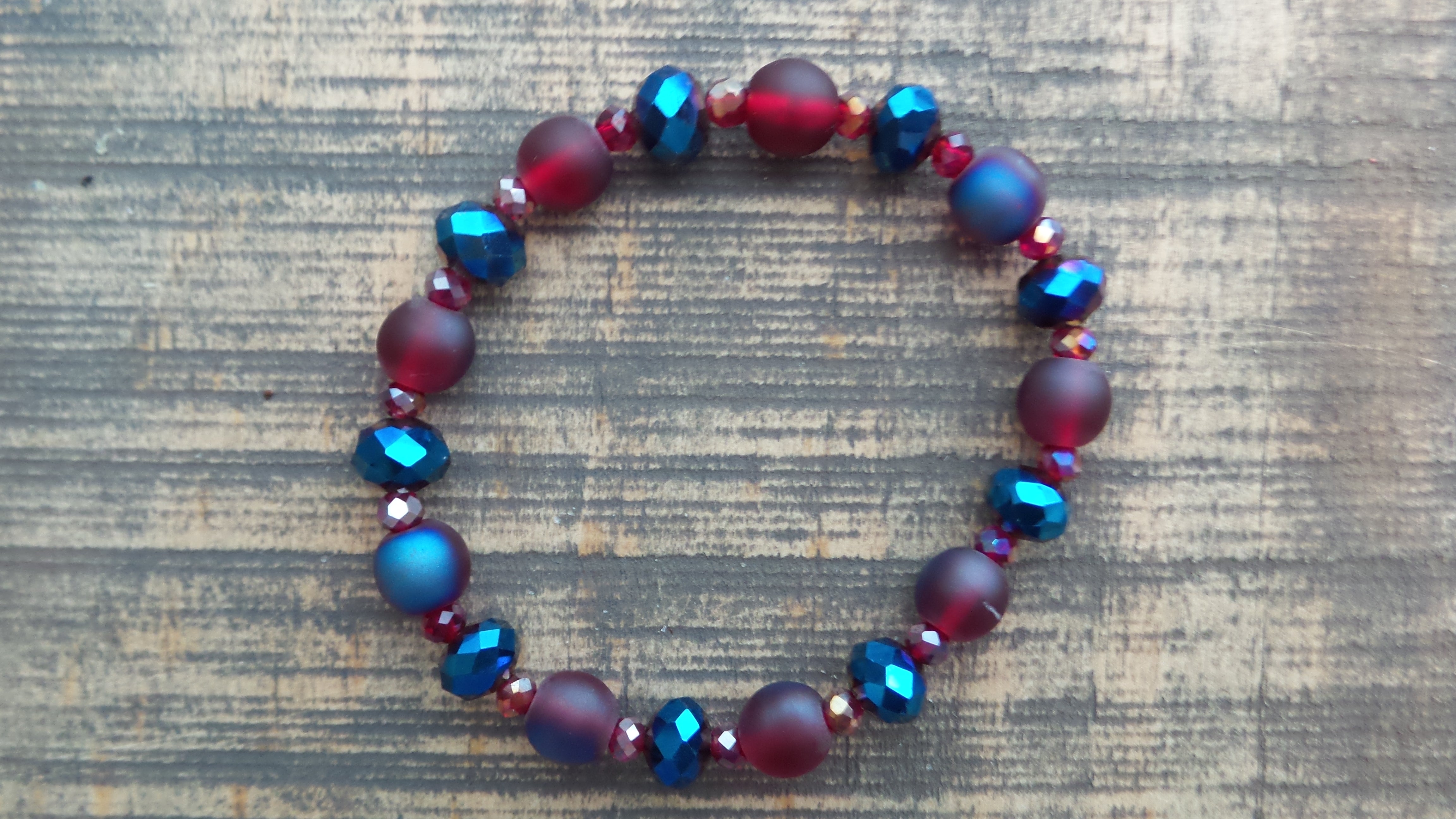 Bracelet- Iridescent Red with Red and Blue Faceted Rondelles