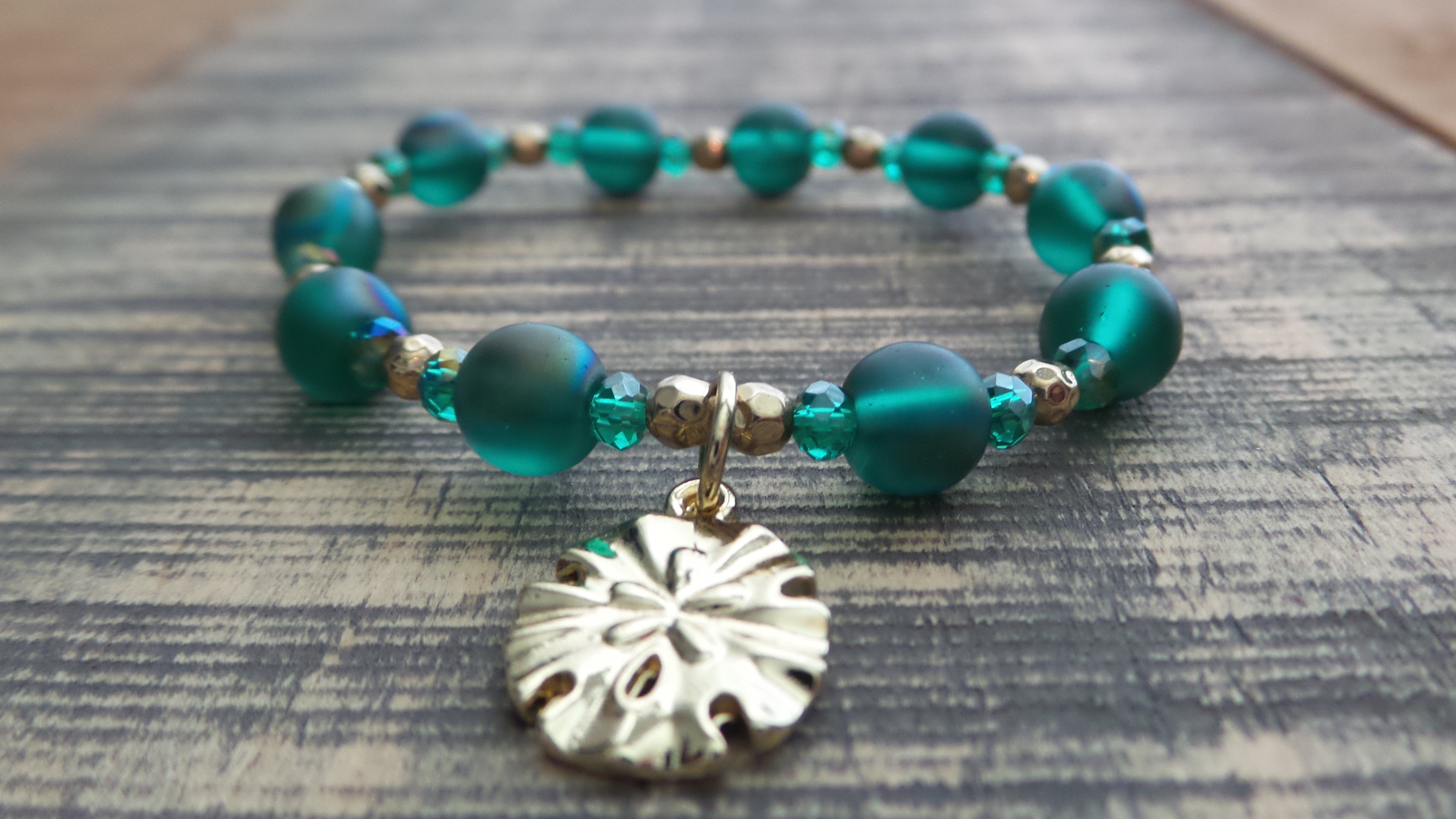 Bracelet- Iridescent Green and Gold with Gold Sand Dollar